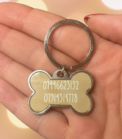 Silver dog bone shaped dog tags